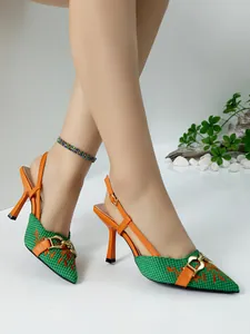 Detail of stylish green and orange slingback heels with gold buckle and woven pattern