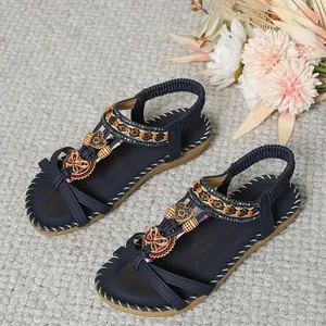 Detailed view of Bohemian navy flat sandals with colorful beads and wooden ornaments.