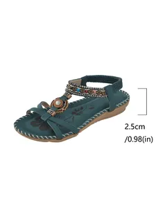 Detail view of bohemian flat sandals with 2.5cm heel height and beaded design