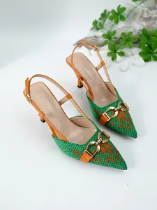 Detailed view of green woven slingback pumps with orange embroidery and gold buckle