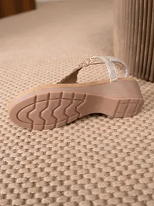 Detail view of bohemian wedge sandal showing non-slip rubber sole and beaded strap
