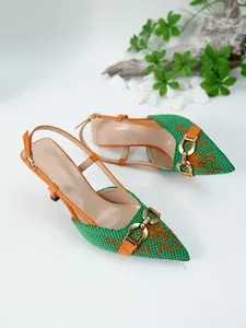 Detailed shot of green woven pointed-toe heels with orange floral embroidery and gold buckle.