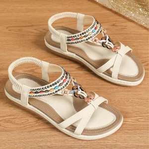 Bohemian flat beach sandals with beaded cross straps and comfortable elastic heel