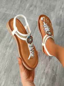 Bohemian flat sandals for women featuring intricate colorful bead and tassel decorations