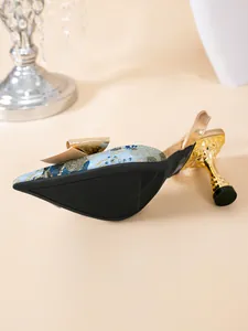Gedetailleerd overzicht van slingback pumps met borduursel, puntige neus en gouden strik