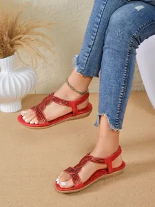 Women's red flat sandals with sparkling rhinestone cross straps for beach