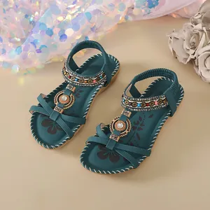 Bohemian flat sandals for women with handmade beadwork and rhinestones on teal straps