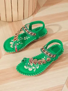 Detailed view of green Bohemian flat sandals with heart beaded flip-flop straps