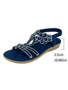 Bohemian blue flat sandals featuring sparkly rhinestone flowers and a 2.5cm low heel