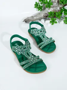 Bohemian green flat sandals with rhinestone floral embellishments on white background