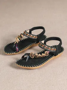Bohemian style flat sandals with ethnic beaded straps and decorative toe-clip elements