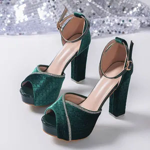 Elegant emerald green velvet platform sandals featuring rhinestone trim and chunky heels