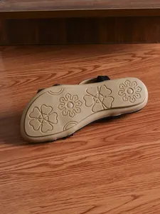 Detailed view of the anti-slip floral patterned sole on vintage ethnic rhinestone sandals.
