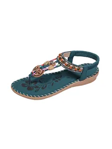 Detail view of Bohemian style women's flat sandals with beaded rhinestones and thong strap