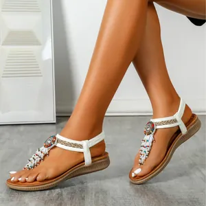 Bohemian flat sandals for women with white straps and colorful beaded tassel detail