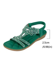 Detail of green bohemian flat sandal showing 2.5cm heel height and rhinestone floral decor