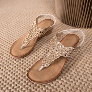 Bohemian style wedge thong sandals featuring intricate rhinestone beading and elastic.