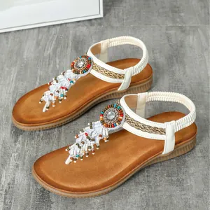 Stylish Bohemian flat sandals for women featuring colorful beads and elegant white tassels