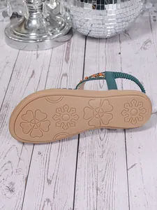 Detailed view of Bohemian flat sandal outsole featuring anti-slip floral texture patterns
