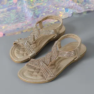 Elegant champagne gold flat sandals for women with rhinestone embellished straps.