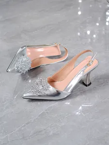 Detailed view of silver rhinestone slingback high heels with pointed toe design