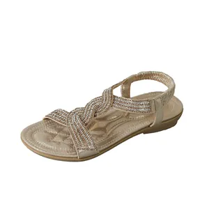 Elegant women's flat beach sandals with sparkling rhinestones and champagne gold finish.