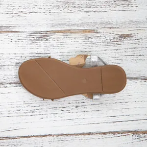Detailed macro view of the textured non-slip brown rubber sole for beach sandals