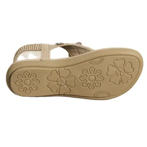 Bottom view showing floral non-slip sole of flat sandals with rhinestone decorations