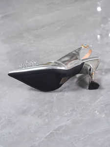 Detail shot showing the silver metallic finish and rhinestone toe decoration of the sandal.
