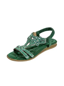 Detail view of Bohemian green flat sandals featuring sparkling rhinestone flower embellishments.