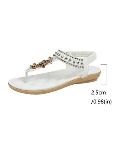 Detail view of white Bohemian flat sandal showing 2.5cm heel height and rhinestones