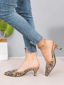 Close-up of colorful rhinestone kitten heel mules with elegant pointed toe design.