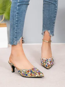 Detail of colorful rhinestone pointed-toe kitten heel mules with vibrant sparkle