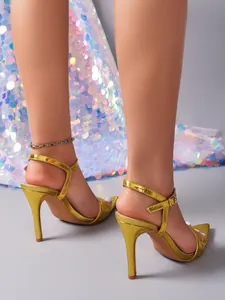 Gedetailleerd achteraanzicht van gouden 9cm sandalen met hoge hak en bandjes.