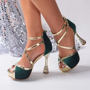 Elegant dark green velvet platform sandals with gold crisscross straps and hourglass heels