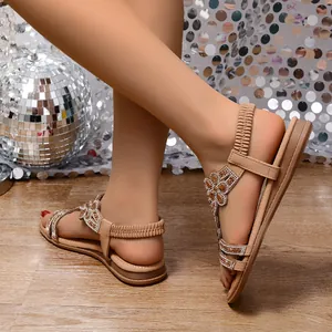 Detail of Bohemian tan flat sandals with sparkling rhinestone flower embellishments