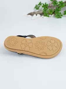 Detailed macro view of the anti-slip floral pattern on the brown sole of Bohemian flat sandals