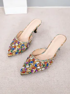 Detail view of pointed-toe kitten heel mules with colorful rhinestones and elegant design.