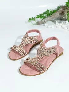 Detail of pink Bohemian flat sandals with sparkling rhinestones and an elastic back strap.