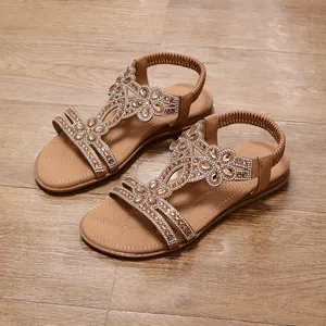 Detailed view of Bohemian flat sandals with rhinestone and bead embellishments