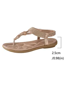Close-up detail showing the 2.5cm heel height on these rose gold bohemian flat sandals.