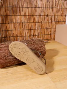 Close-up detail of the anti-slip tan sole on Bohemian beaded flat sandals for women