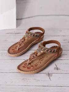 Detailed look at Bohemian style brown flat sandals featuring rhinestones and floral accents