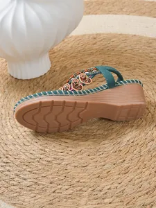 Detailed view of Bohemian teal wedge sandals with colorful beads and durable sole design