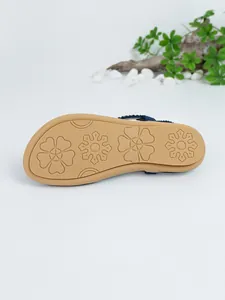 Detailed view of the tan anti-slip rubber outsole with floral pattern for women sandals