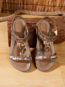 Close-up view showing the intricate beading on brown bohemian ethnic flat sandals for women