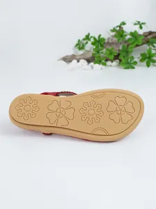 Detailed view of the anti-slip sole of a Bohemian flat sandal with floral patterns