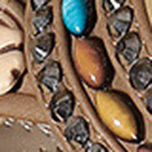 Macro view of handmade colorful beads and stitching on Bohemian flat sandals
