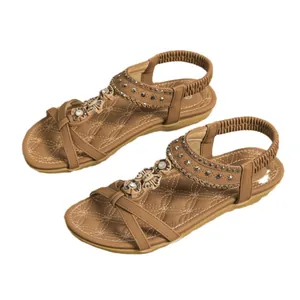 Bohemian style women's flat sandals featuring beaded flowers and elastic back strap in tan