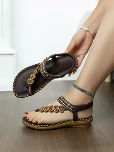 Detailed view of Bohemian beaded flat sandals with rhinestone hearts and elastic strap